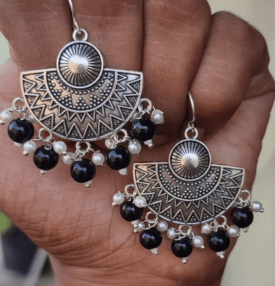 Hand with gold jewelry and bracelet